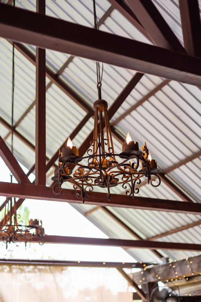 A rustic chandelier in a barn wedding venue in Austin